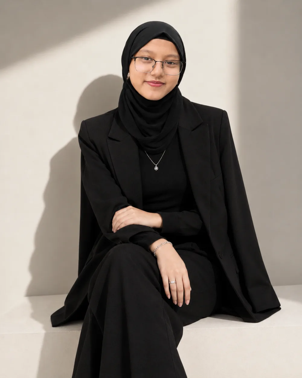 Mahbuba Saniya seated in a black suit